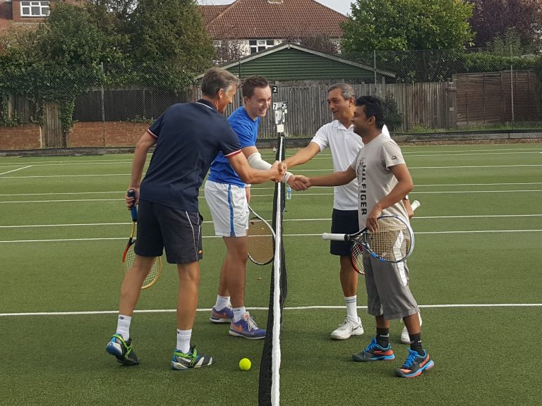 Players shaking hands across the net at the end of a match