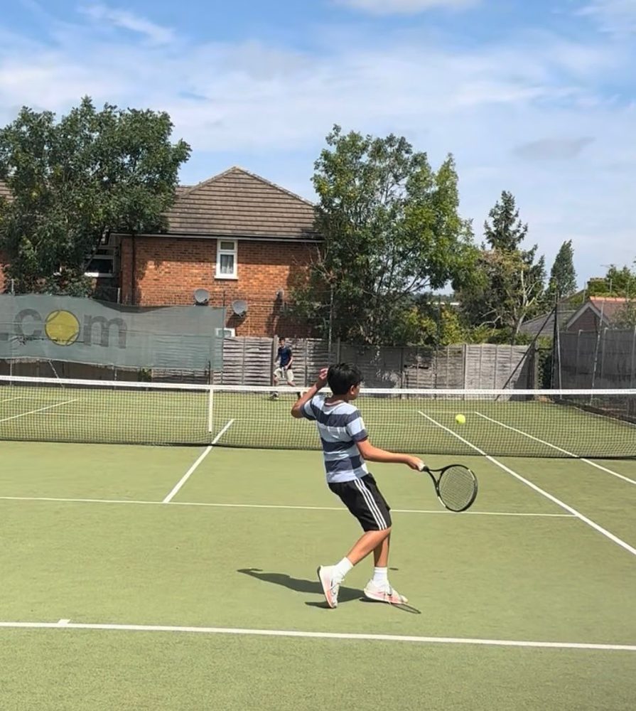 A junior player hitting a forehand during a coaching session at Headstone