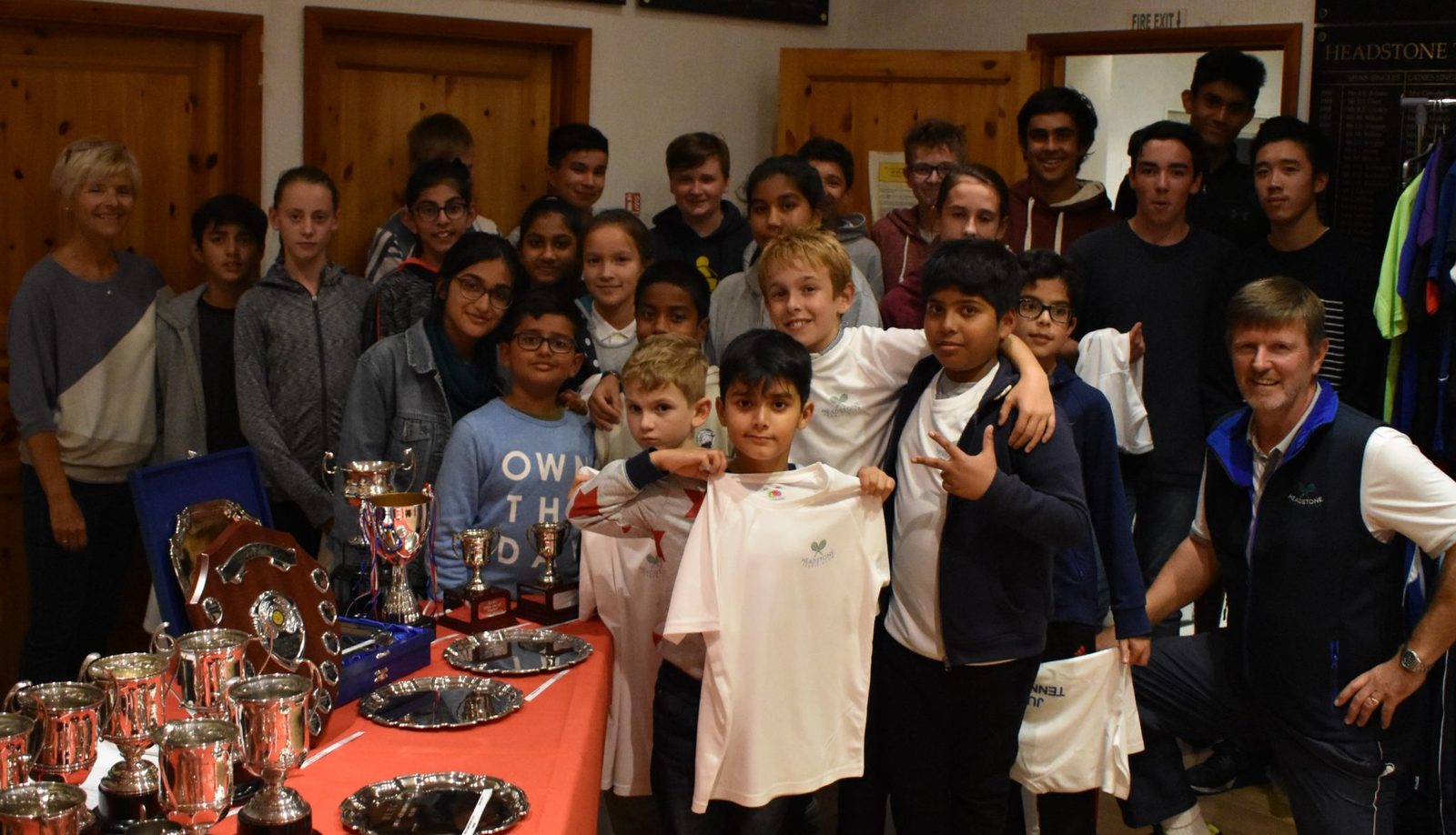 Headstone Tennis Club juniors gathered around the trophy table at the junior presentation evening